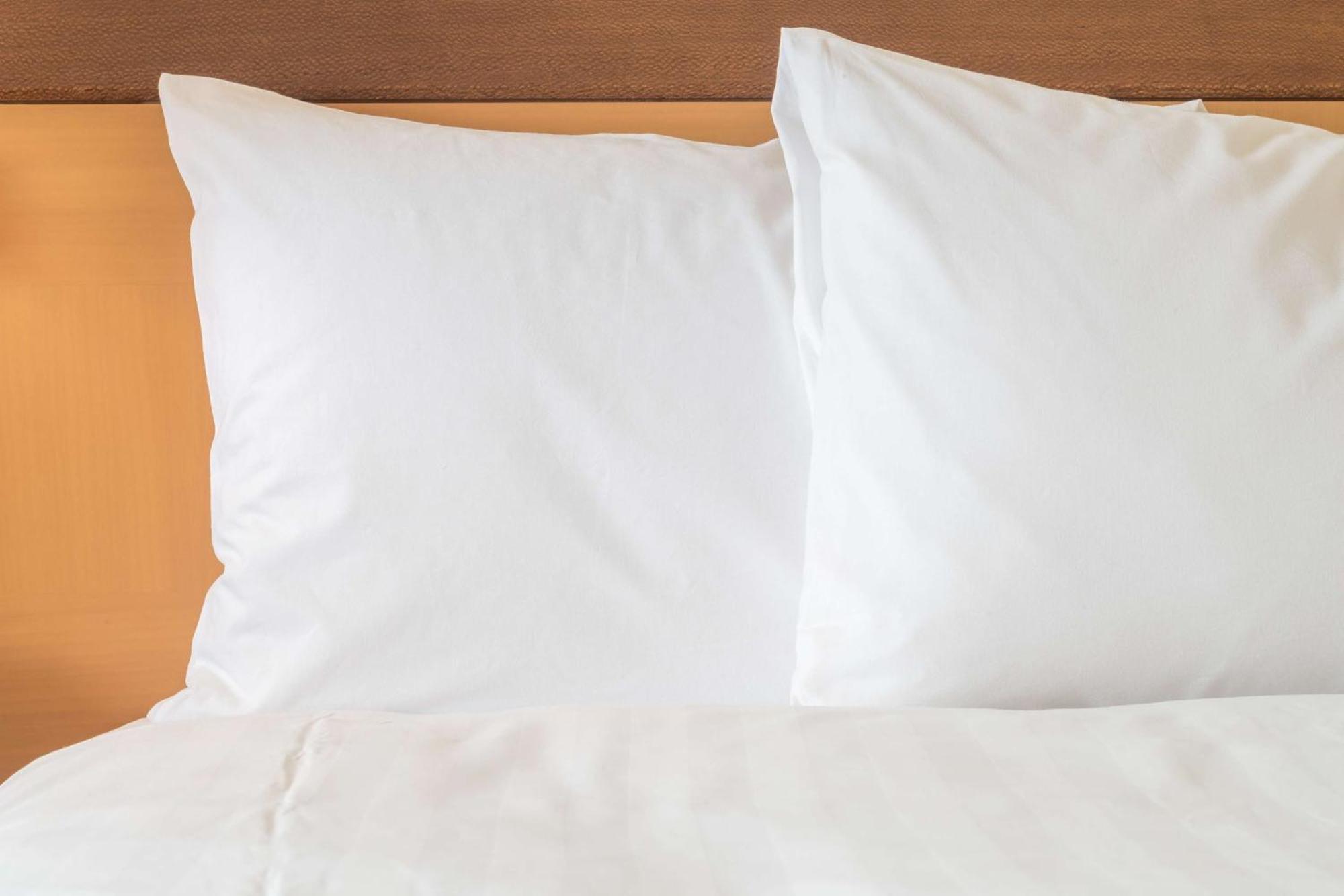Holiday Inn Gurugram Sector 90 By Ihg Gurgaon Exterior photo Two pillows on a bed